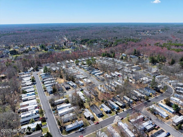 birds eye view of property with a wooded view