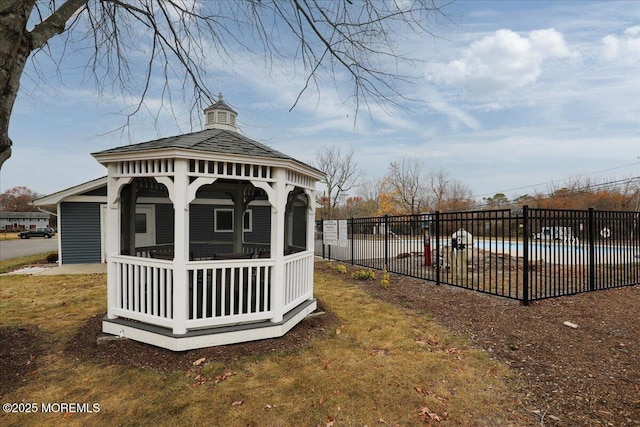 view of yard featuring a gazebo, fence, and a fenced in pool