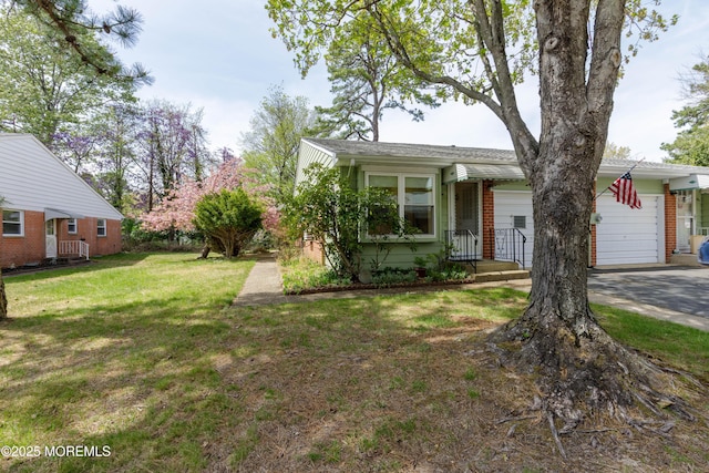 view of front of property featuring an attached garage, concrete driveway, brick siding, and a front yard