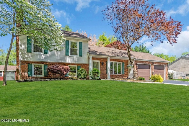 5 Beth Dr, Middletown, NJ 07748 - tri-level home with an attached garage, brick siding, driveway, and a front yard
