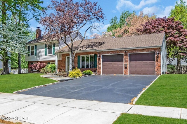 5 Beth Dr, Middletown, NJ 07748 - tri-level home featuring aphalt driveway, a chimney, brick siding, a front lawn, and an attached garage