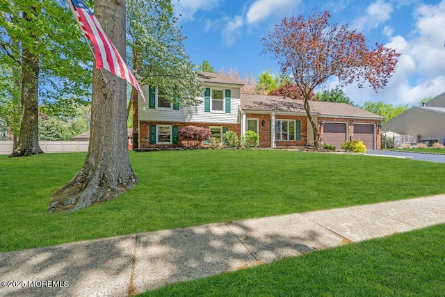5 Beth Dr, Middletown, NJ 07748 - split level home featuring fence, an attached garage, brick siding, a front yard, and concrete driveway