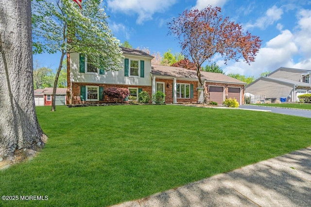 5 Beth Dr, Middletown, NJ 07748 - tri-level home featuring concrete driveway, brick siding, an attached garage, and a front lawn