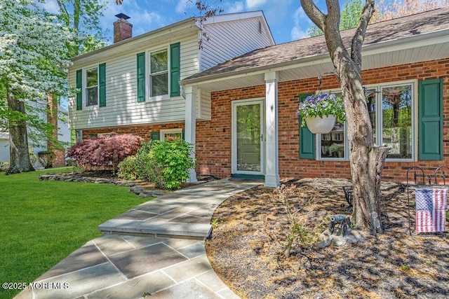5 Beth Dr, Middletown, NJ 07748 - split level home featuring brick siding, a chimney, and a front lawn