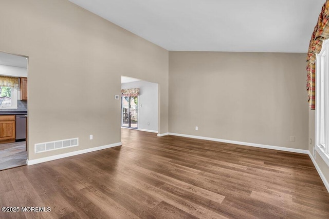 5 Beth Dr, Middletown, NJ 07748 - unfurnished living room with dark wood-style flooring, baseboards, visible vents, and high vaulted ceiling