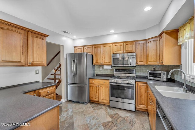 5 Beth Dr, Middletown, NJ 07748 - kitchen with visible vents, appliances with stainless steel finishes, tasteful backsplash, dark countertops, and a sink