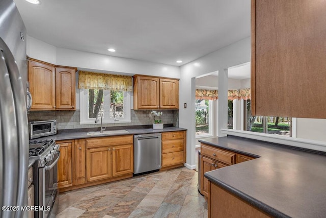 5 Beth Dr, Middletown, NJ 07748 - kitchen with stainless steel appliances, dark countertops, a healthy amount of sunlight, and a sink