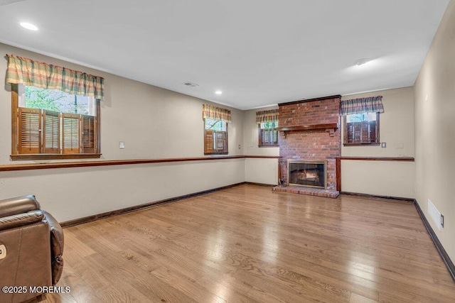 5 Beth Dr, Middletown, NJ 07748 - unfurnished living room with baseboards, a wealth of natural light, wood finished floors, and a fireplace