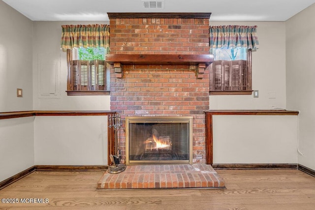 5 Beth Dr, Middletown, NJ 07748 - unfurnished living room featuring visible vents, baseboards, wood finished floors, and a fireplace