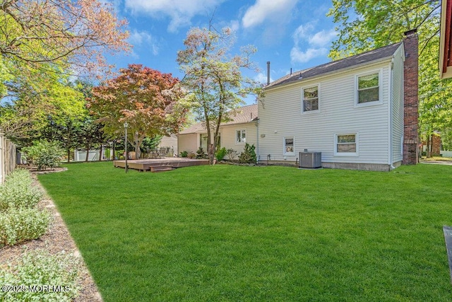 5 Beth Dr, Middletown, NJ 07748 - back of house with a lawn, a deck, a chimney, and a fenced backyard
