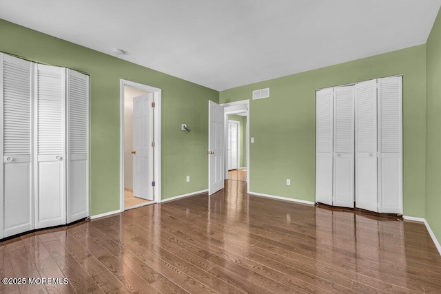 5 Beth Dr, Middletown, NJ 07748 - unfurnished bedroom featuring two closets, baseboards, visible vents, and wood finished floors