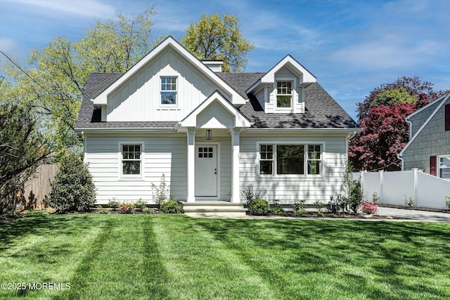 26 Rumson Pl, Little Silver, NJ 07739 - view of front facade with board and batten siding, roof with shingles, fence, and a front yard