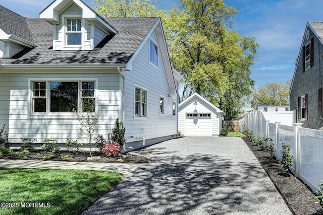 26 Rumson Pl, Little Silver, NJ 07739 - view of home's exterior with roof with shingles, an outbuilding, a garage, fence, and aphalt driveway