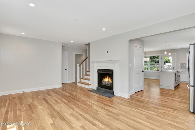 26 Rumson Pl, Little Silver, NJ 07739 - unfurnished living room with baseboards, recessed lighting, light wood finished floors, and a fireplace with flush hearth