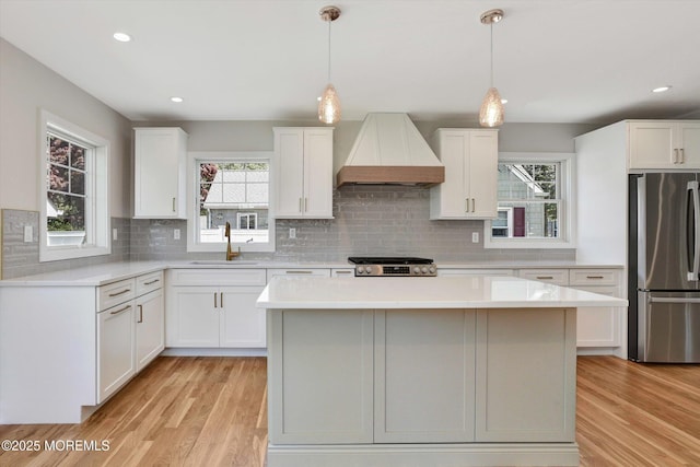 26 Rumson Pl, Little Silver, NJ 07739 - kitchen featuring tasteful backsplash, a sink, freestanding refrigerator, custom exhaust hood, and light wood-style floors