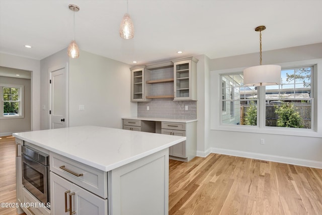 26 Rumson Pl, Little Silver, NJ 07739 - kitchen featuring open shelves, light wood-type flooring, light countertops, baseboards, and stainless steel microwave