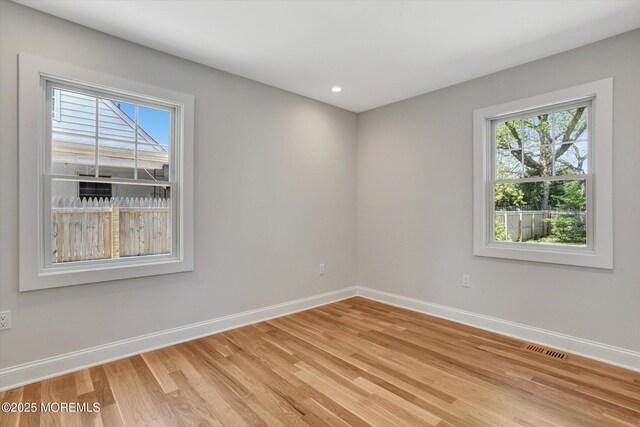 26 Rumson Pl, Little Silver, NJ 07739 - empty room with baseboards, plenty of natural light, and light wood-style flooring