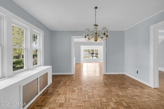 unfurnished dining area featuring a healthy amount of sunlight, baseboards, visible vents, and a notable chandelier