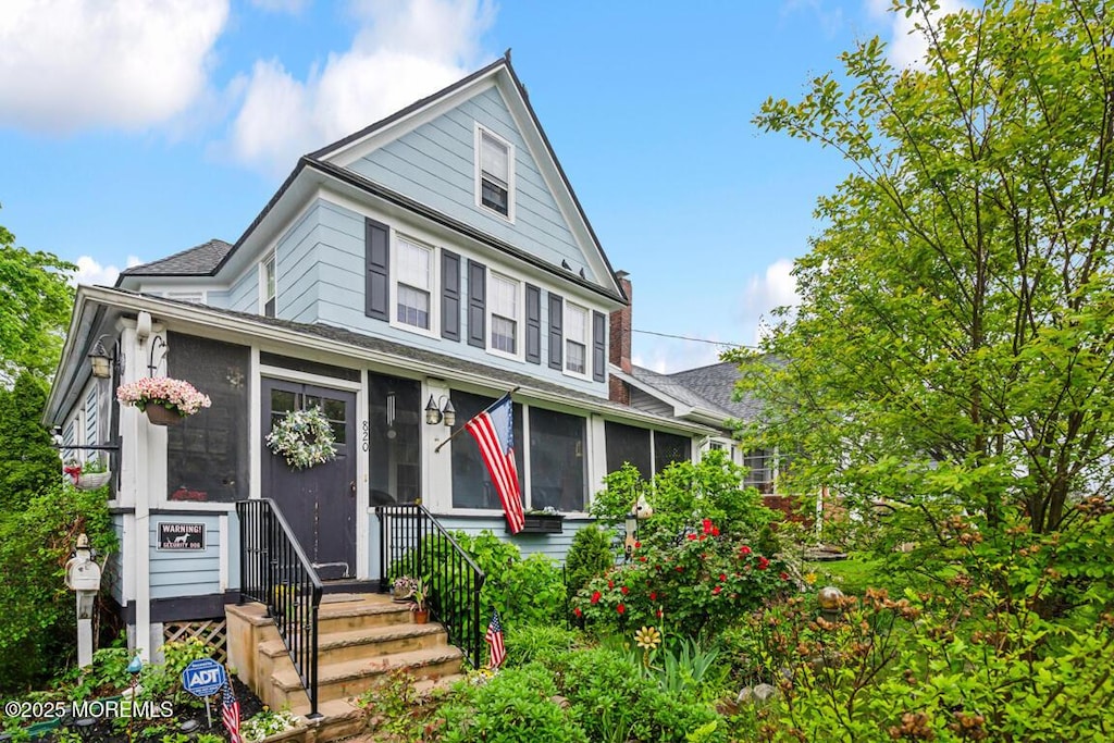 820 Trenton Ave, Point Pleasant, NJ 08742 - view of front of house featuring a sunroom and roof with shingles
