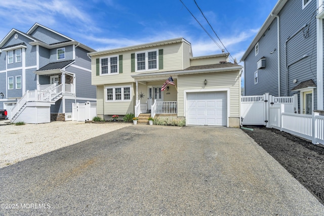 view of front facade featuring a garage, aphalt driveway, fence, covered porch, and a gate