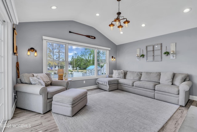 living area with recessed lighting, lofted ceiling, and light wood finished floors