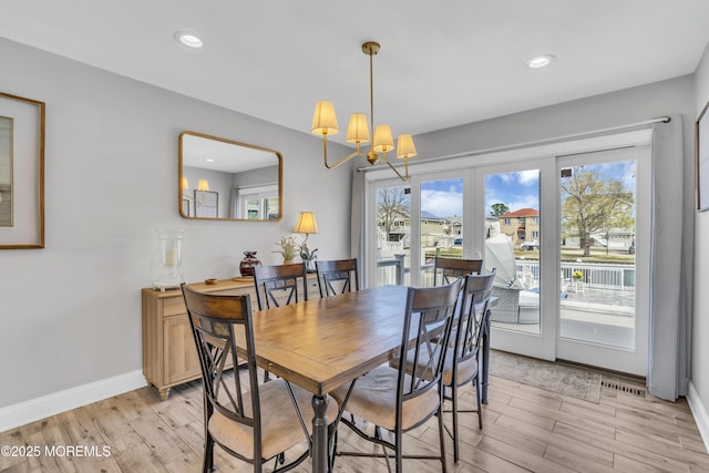 dining space with recessed lighting, plenty of natural light, and light wood-type flooring