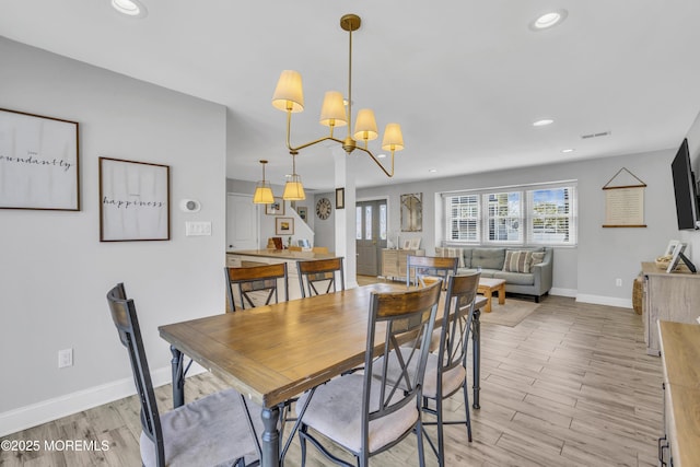 dining area with visible vents, baseboards, light wood-style floors, recessed lighting, and a notable chandelier