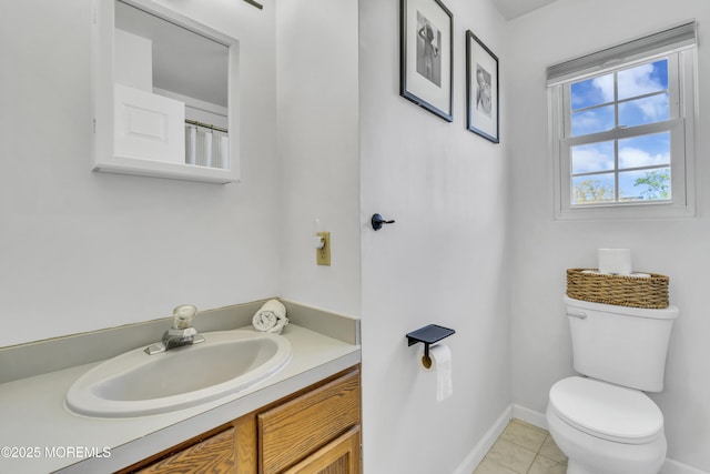 bathroom with toilet, baseboards, tile patterned flooring, and vanity