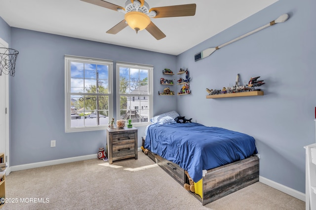carpeted bedroom with baseboards and a ceiling fan