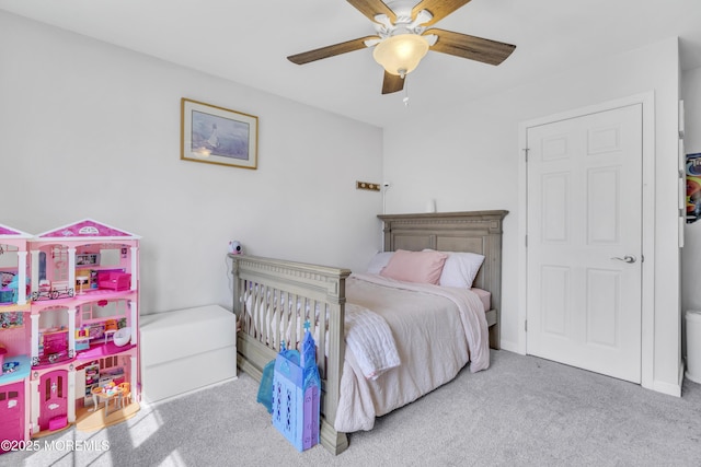 bedroom with a ceiling fan and carpet flooring