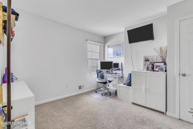 office area featuring baseboards, visible vents, and carpet