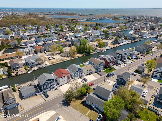 birds eye view of property featuring a residential view and a water view