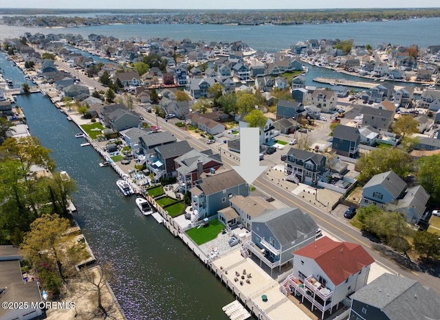 bird's eye view featuring a water view and a residential view