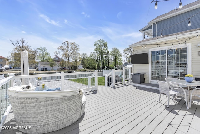 wooden terrace with outdoor dining space