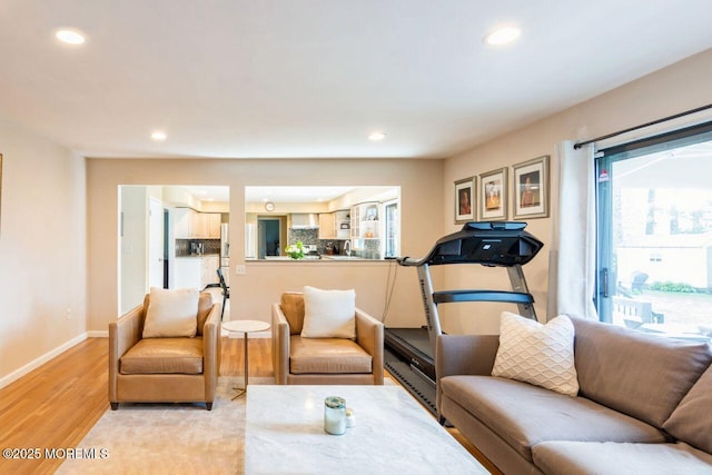 living area with recessed lighting, light wood-type flooring, and a wealth of natural light