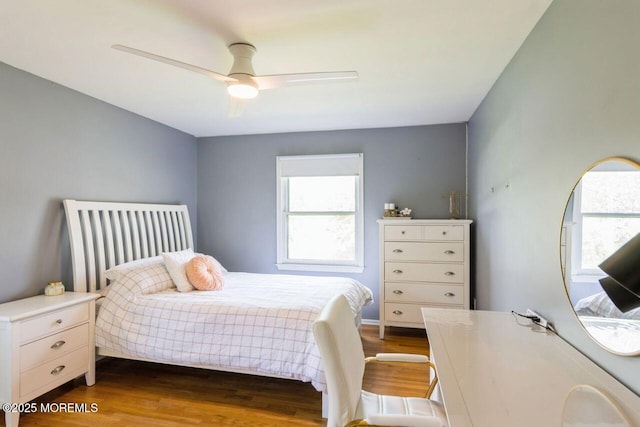 bedroom featuring multiple windows, ceiling fan, and dark wood-type flooring