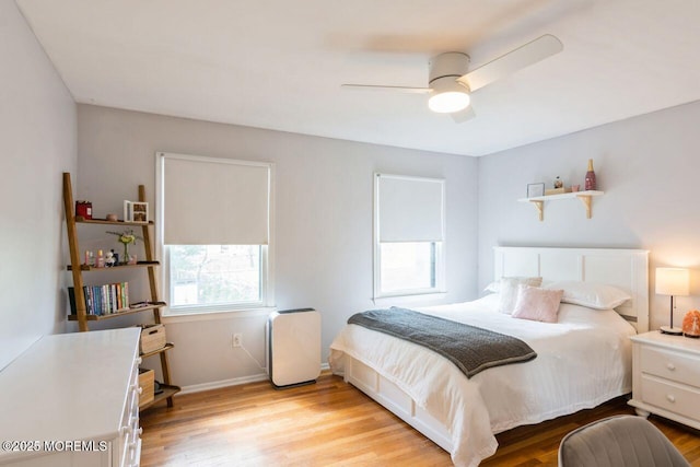 bedroom featuring baseboards, a ceiling fan, and wood finished floors