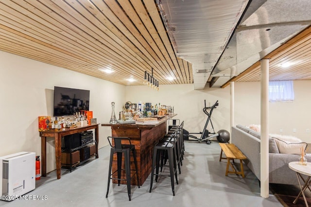 bar with concrete flooring and a dry bar