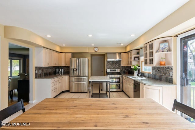 kitchen with wall chimney range hood, appliances with stainless steel finishes, light tile patterned floors, and open shelves