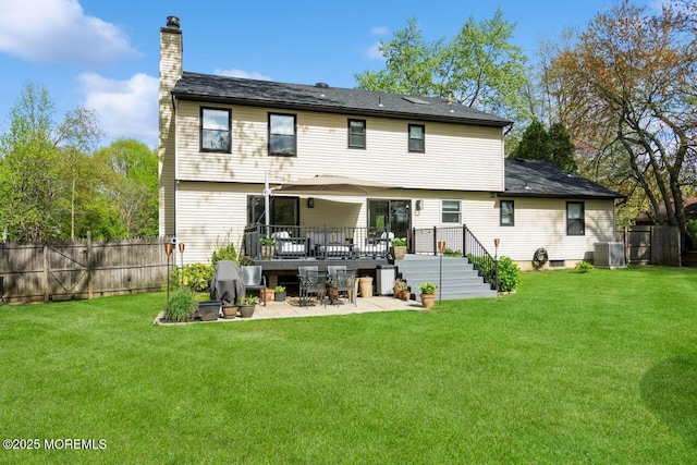 rear view of house featuring a fenced backyard, a patio area, a yard, and a chimney
