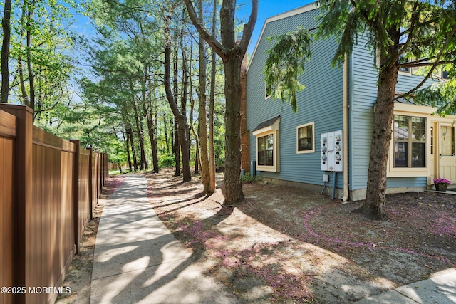 view of side of property featuring fence