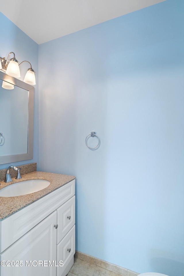 bathroom with baseboards and vanity