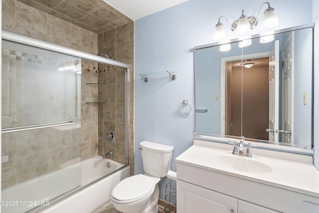 bathroom featuring toilet, vanity, and shower / bath combination with glass door