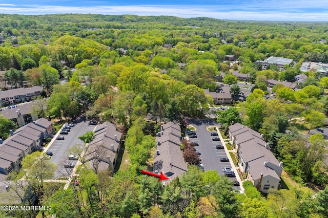 birds eye view of property with a forest view and a residential view