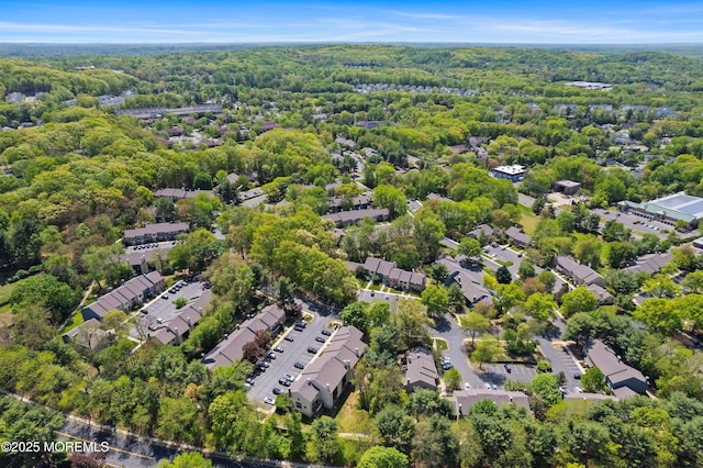 aerial view featuring a wooded view