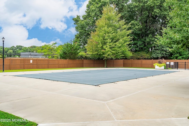 pool featuring fence and a patio