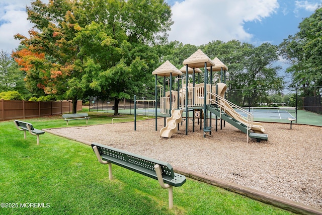 community playground with a yard and fence