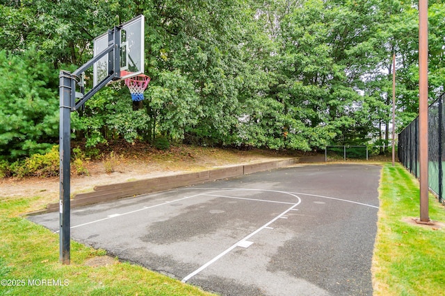view of basketball court with fence and basketball court