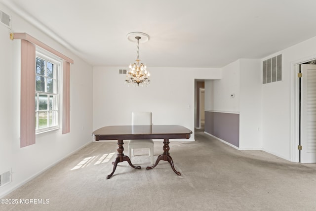 dining room with visible vents, baseboards, carpet floors, and a notable chandelier