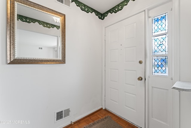 foyer with baseboards and visible vents